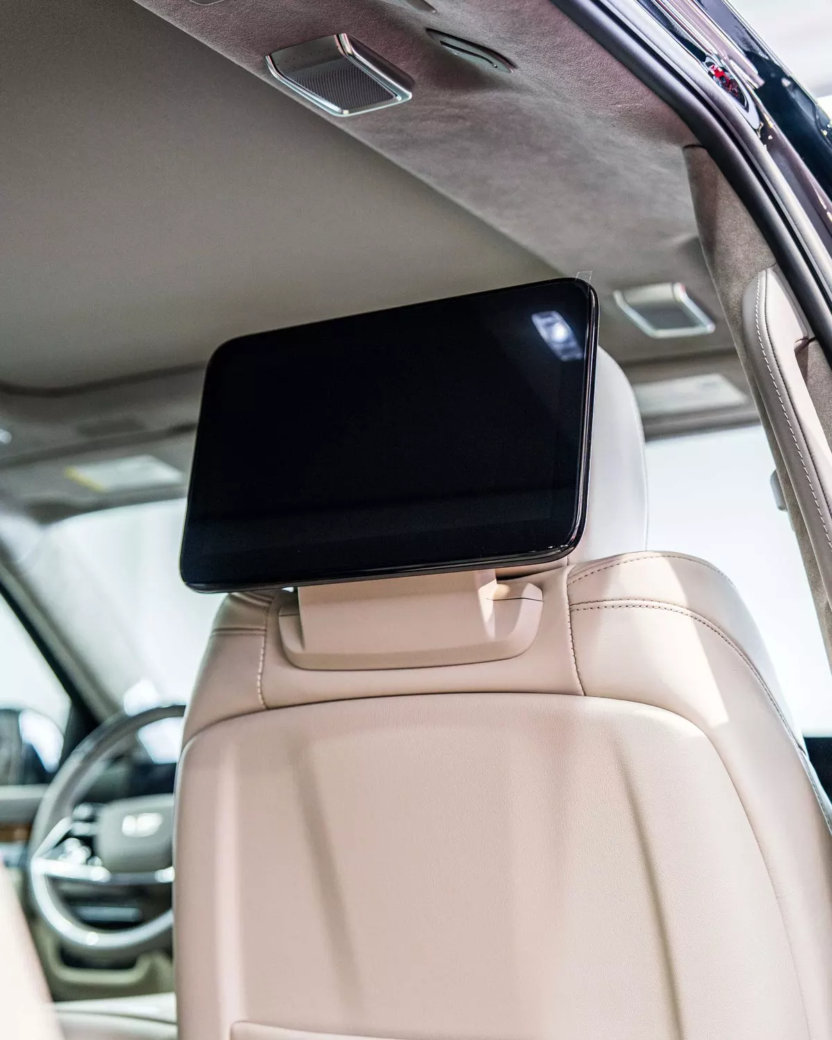 Rear entertainment screen mounted behind an Escalade front seat