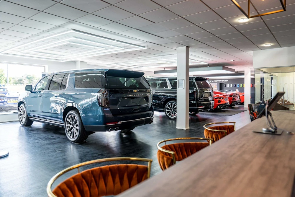 View across the bar towards a Chevrolet Suburban in the showroom
