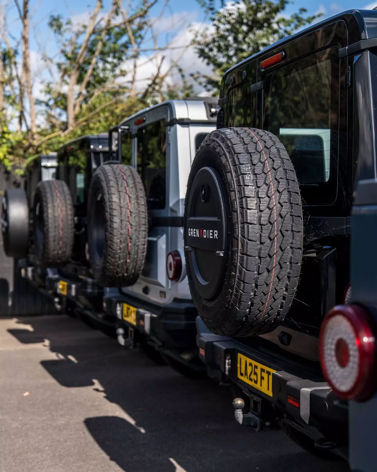 Rear-mounted spare wheels on Grenadiers outside INEOS Midlands