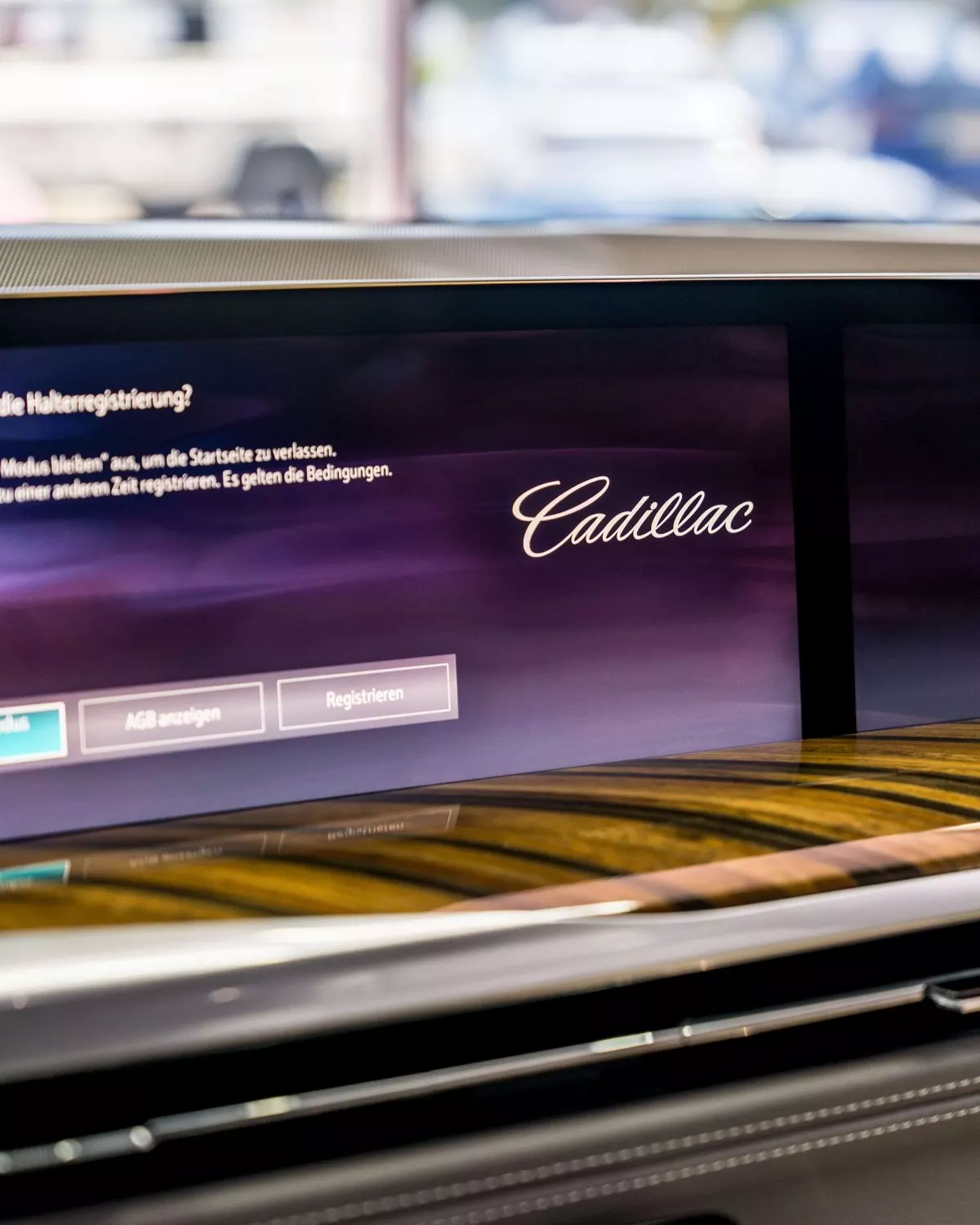 Cadillac passenger-side dashboard display showing the Cadillac wordmark