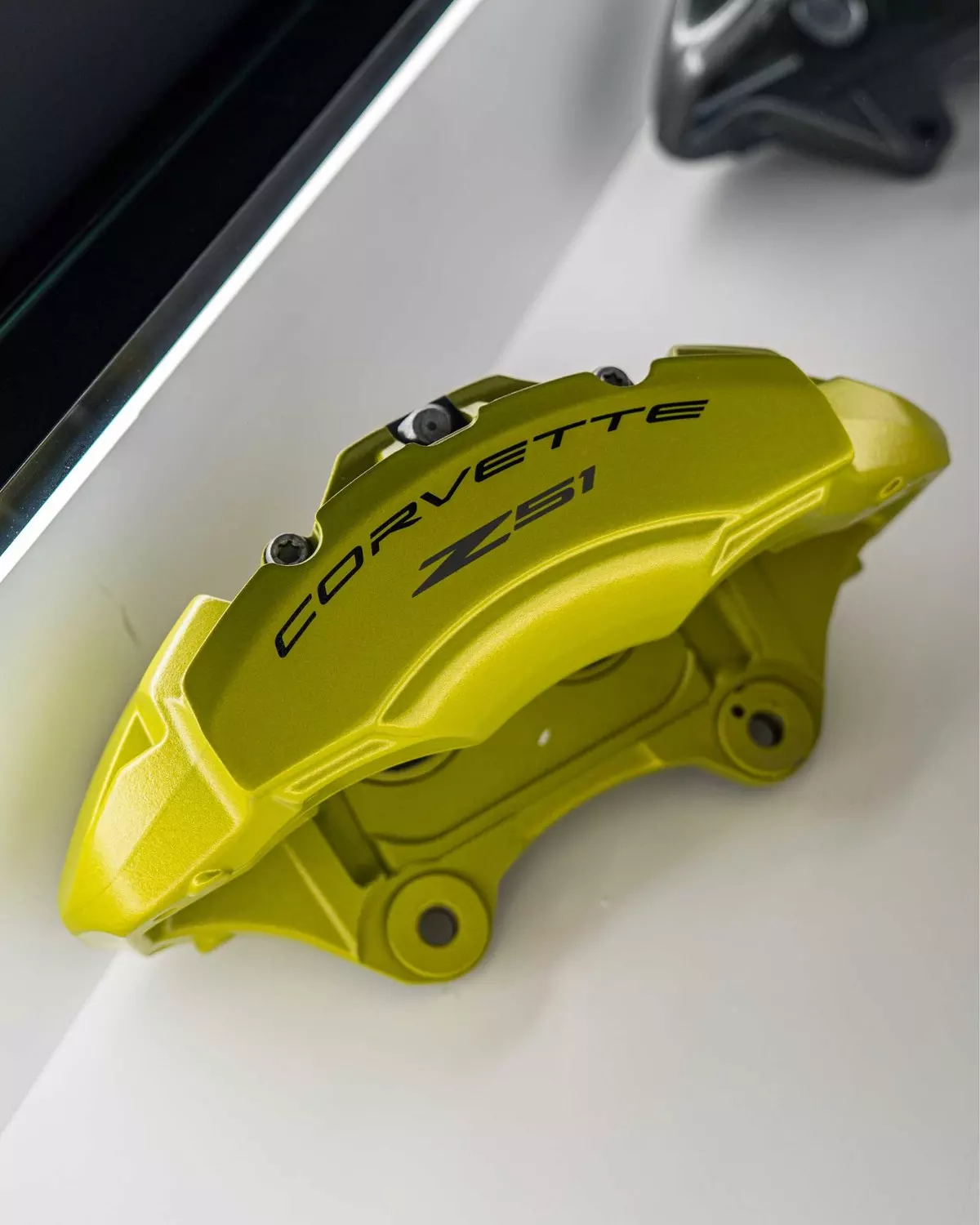 Yellow Corvette brake caliper on the showroom display