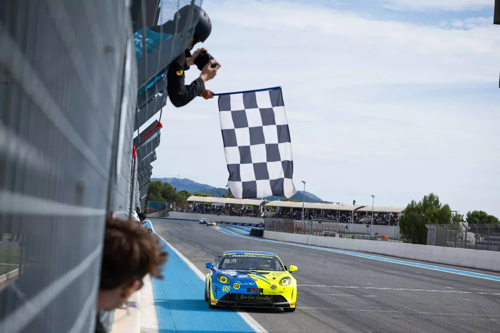 Chequered flag over an Alpine race car at Circuit Paul Ricard