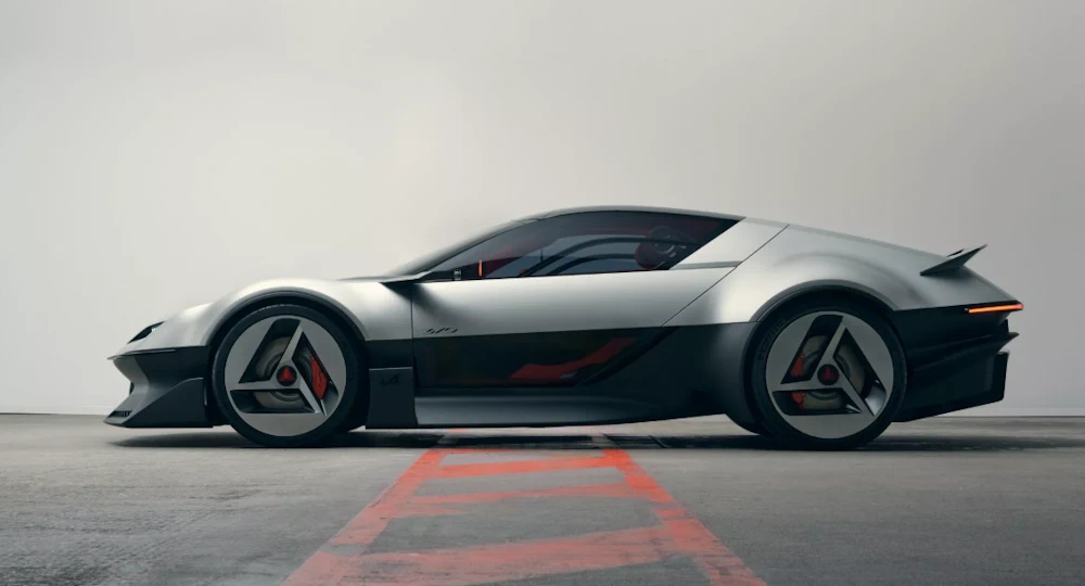 Side profile of the Alpine A310 VISION showing its low roof and triangular wheels
