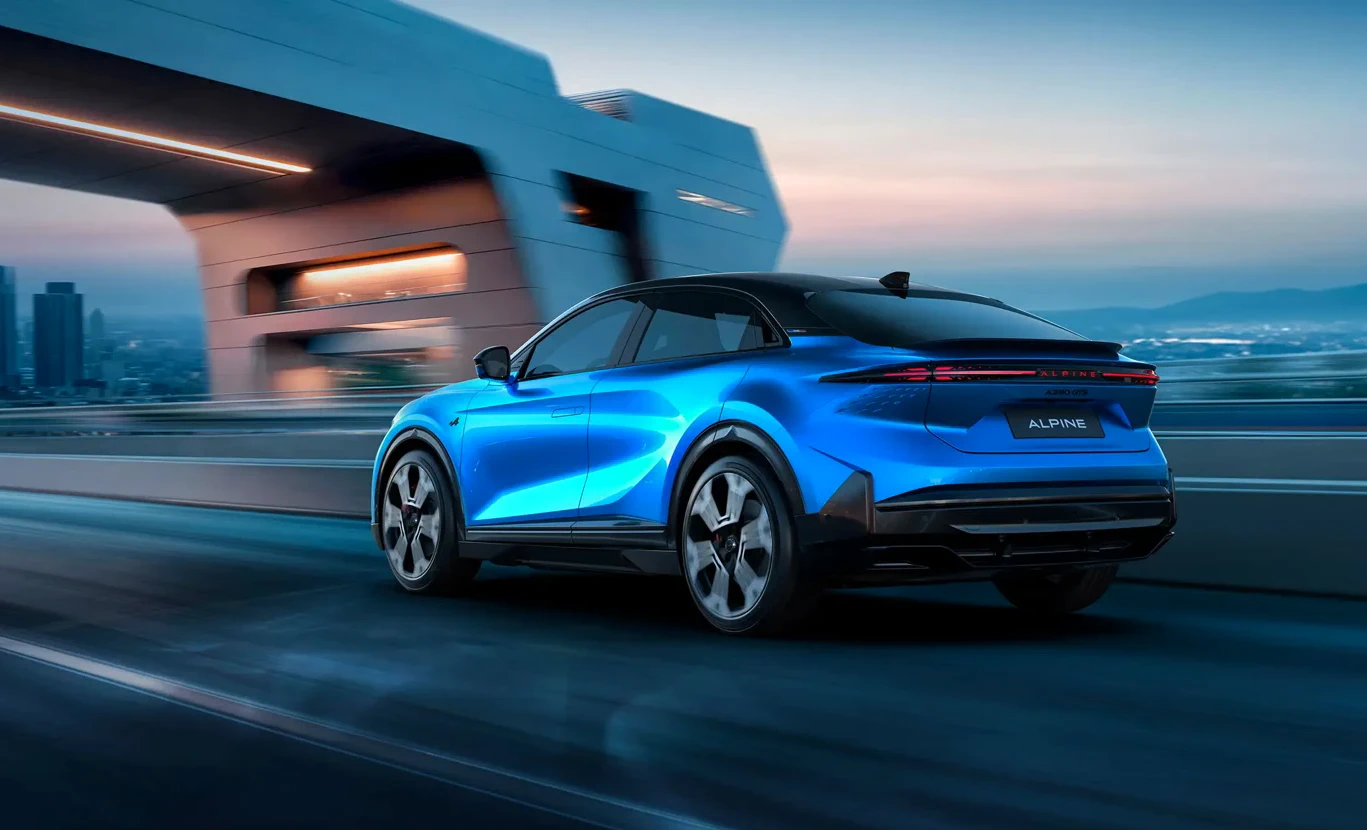 Blue Alpine A390 driving through a city in official manufacturer photography