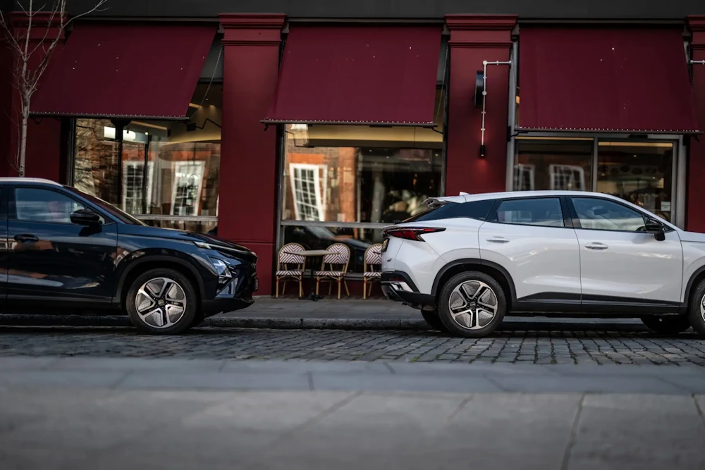 Two OMODA SUVs parked on a city street