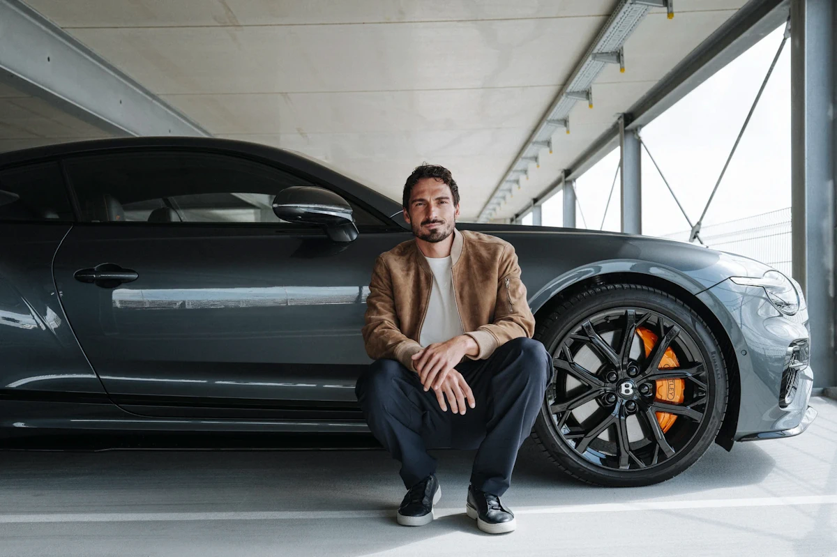 Mats Hummels beside a Bentley Continental GT in official Bentley campaign photography