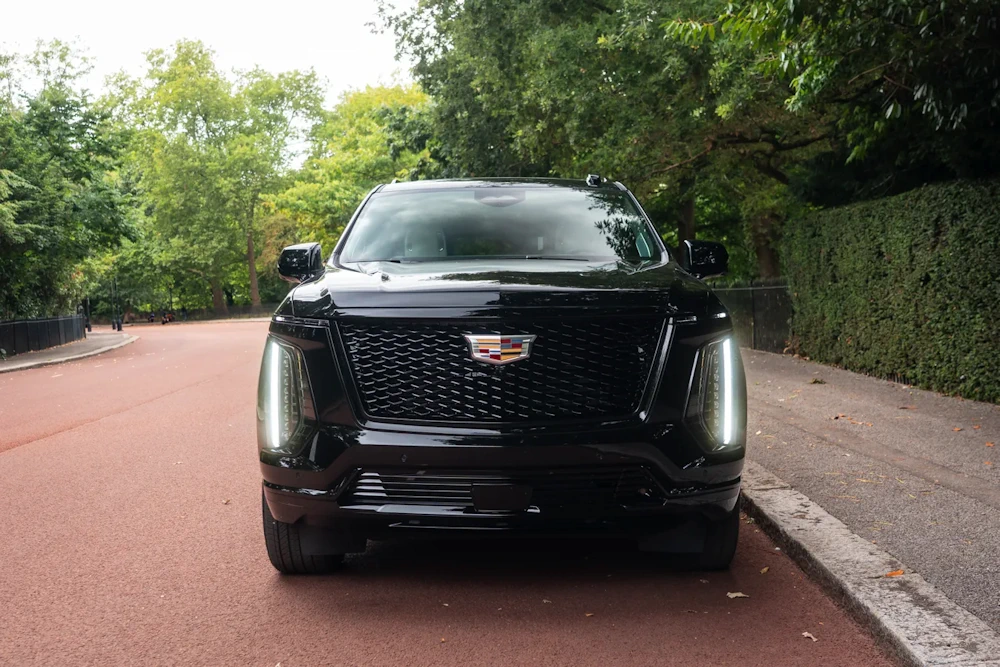 Cadillac Escalade photographed on a tree-lined road