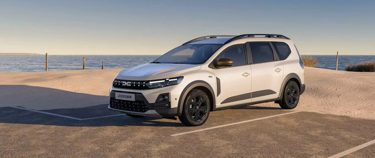 White Dacia Jogger driving on a coastal road