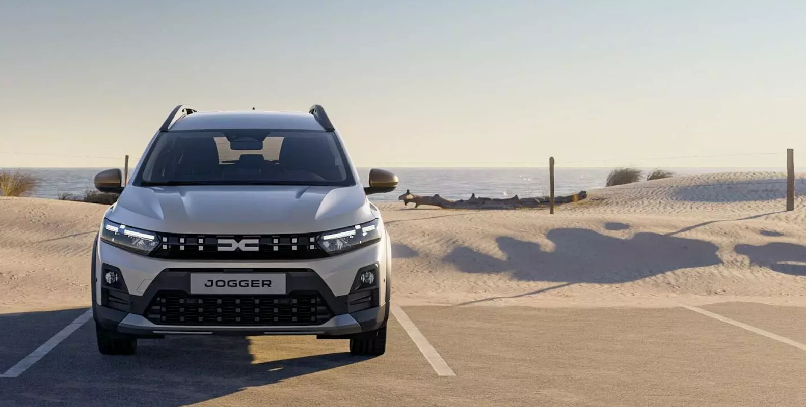 White Dacia Jogger viewed from the front on a coastal road