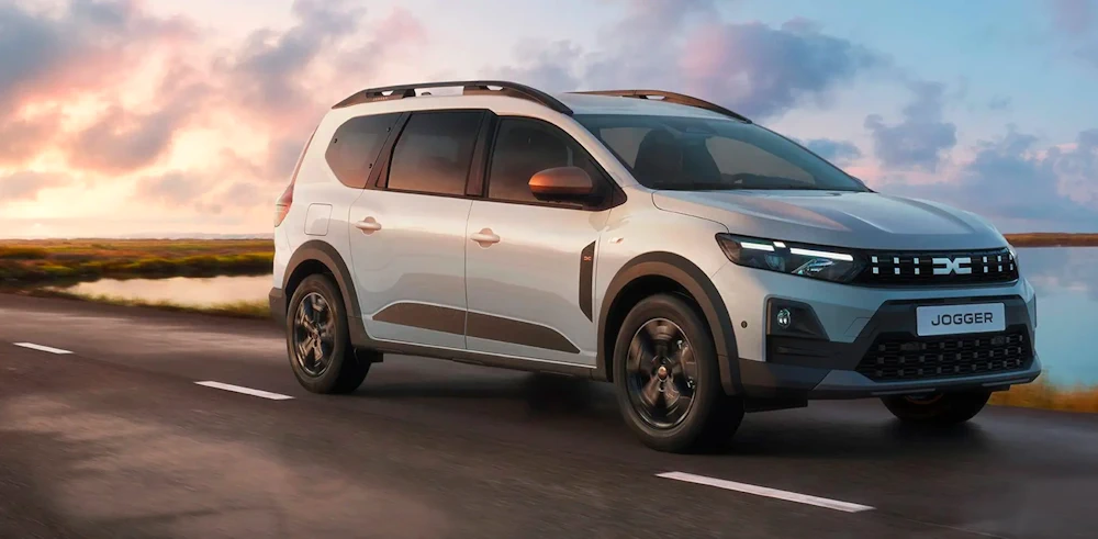 White Dacia Jogger driving at sunset