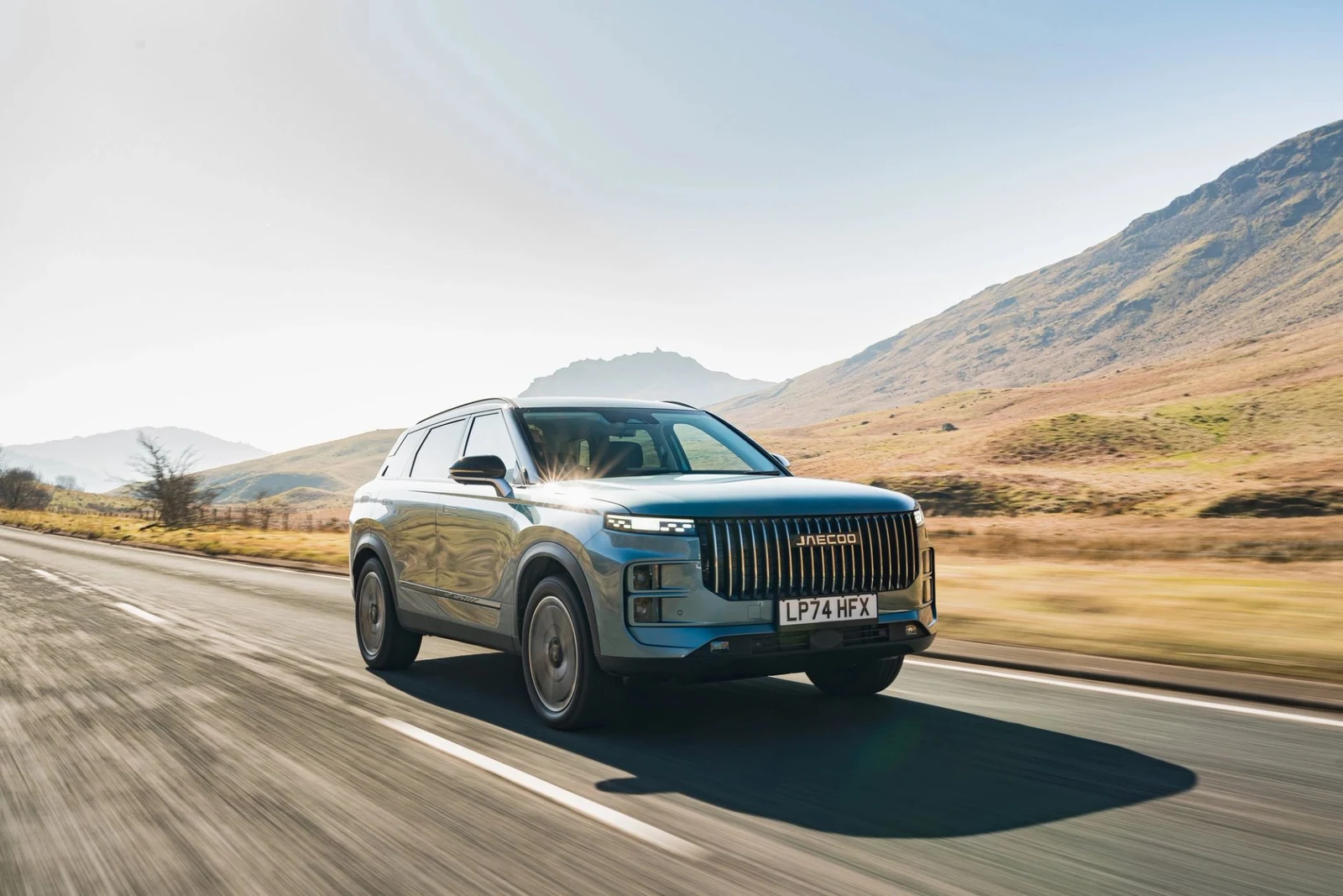JAECOO 7 SUV photographed on a road beside hills