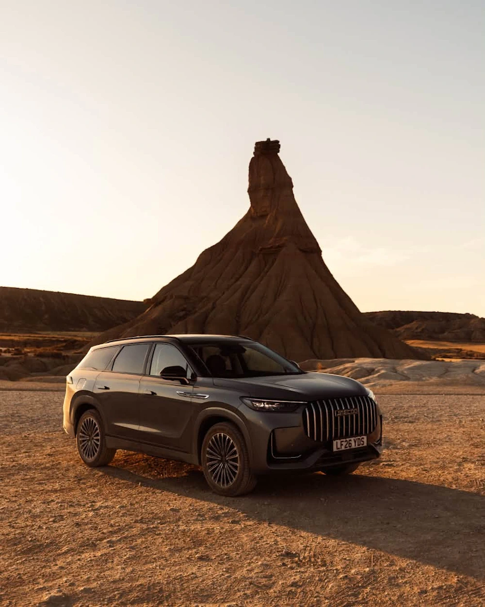 JAECOO 8 parked on a track in the warm evening light at Bardenas Reales