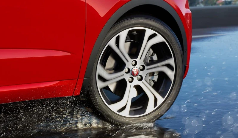 Jaguar wheel and tyre on a wet road surface