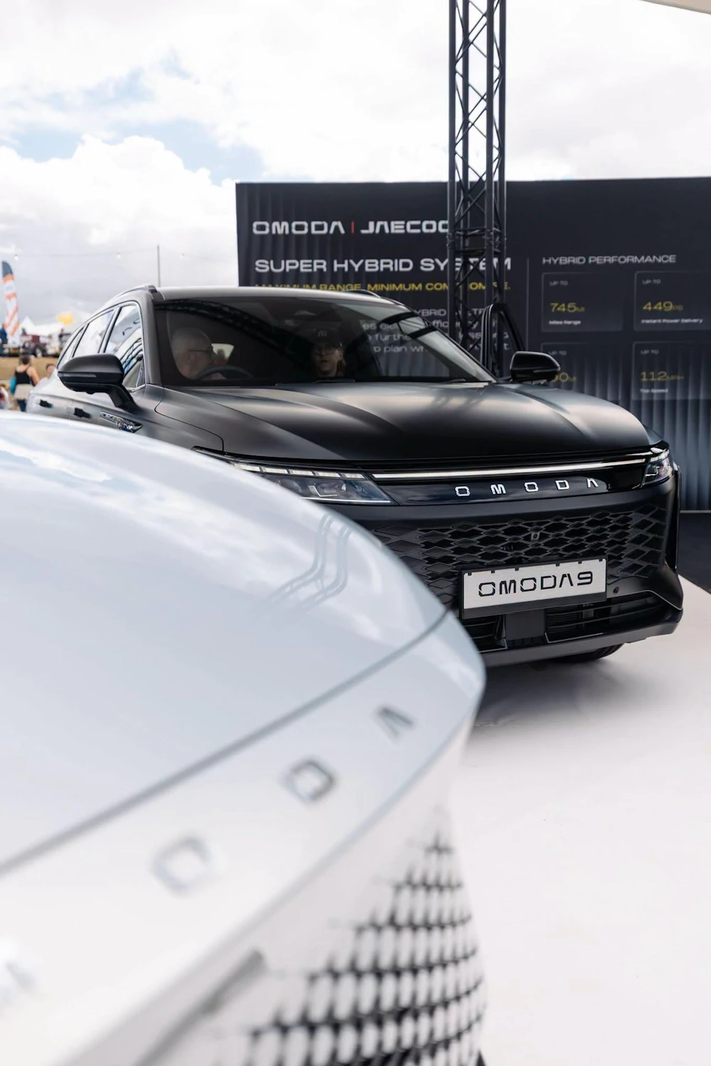 Black OMODA 9 seen from the front at a brand display
