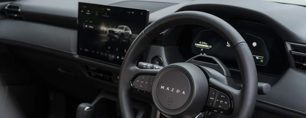Close-up of the all-new Mazda CX-5 steering wheel and driver display