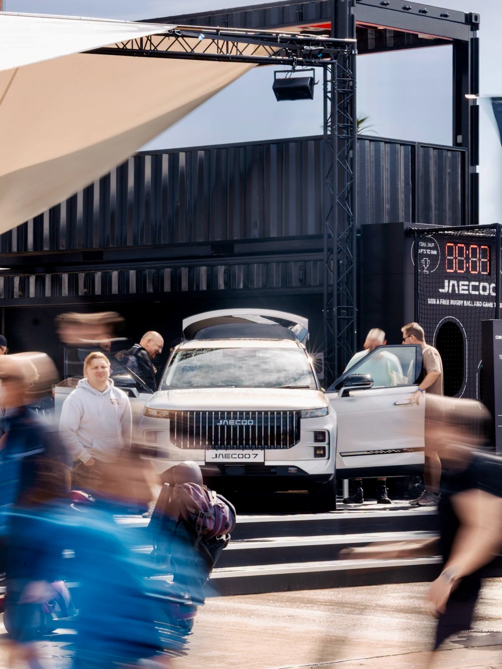 Visitors exploring a JAECOO 7 on the OMODA and JAECOO stand at CarFest 2026