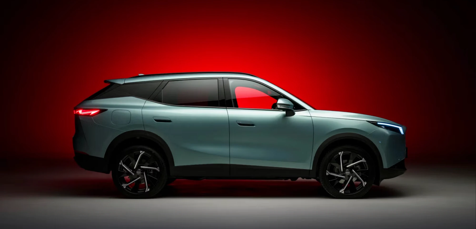 OMODA 7 SUV driving on a coastal road