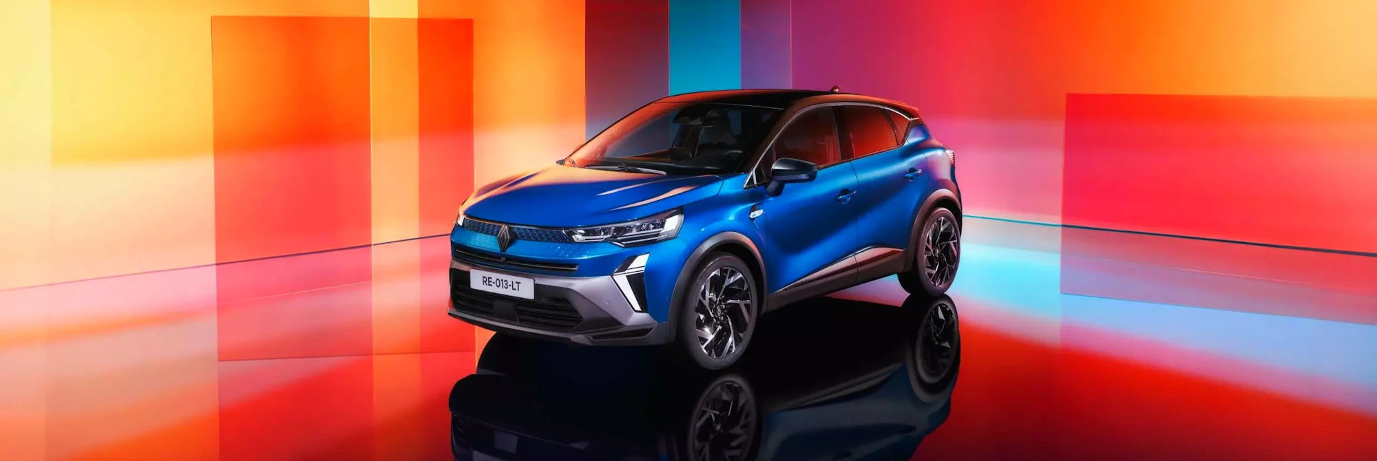 Renault Captur full hybrid compact SUV driving in a city