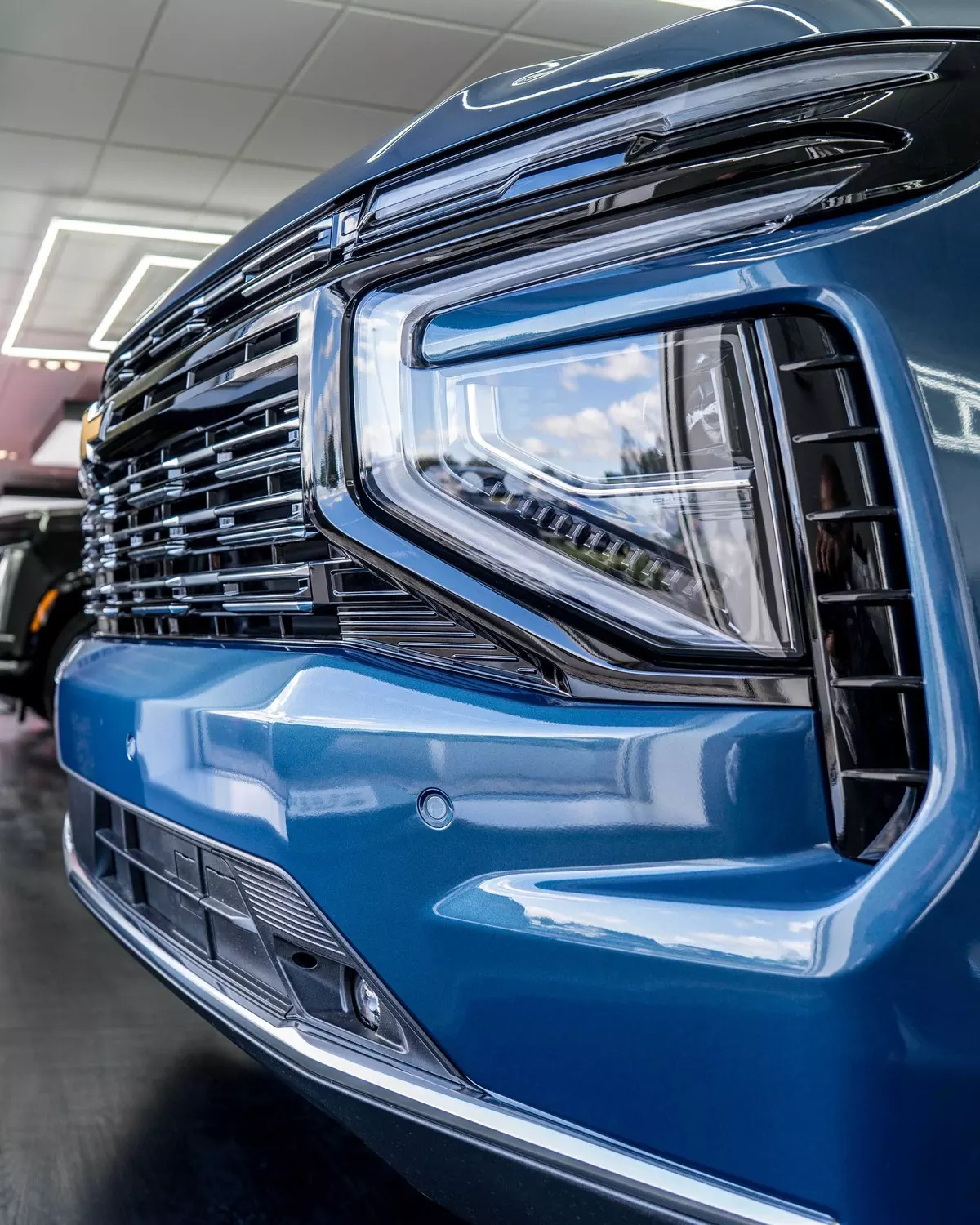 Close-up of the Suburban LED headlamp and blue front bodywork